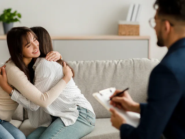 Una pareja se abraza durante una sesión de terapia